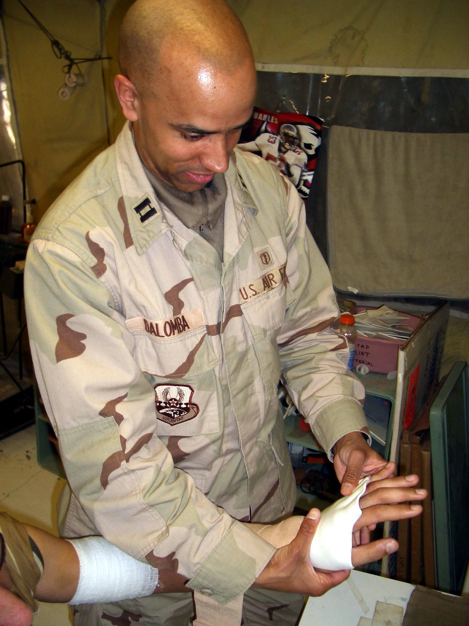 BALAD AIR BASE, Iraq -- Capt. John DaLomba places a hand splint on a patient at the physical and occupational therapy clinic here.  (U.S. Air Force photo by Senior Airman Joseph Flores)
