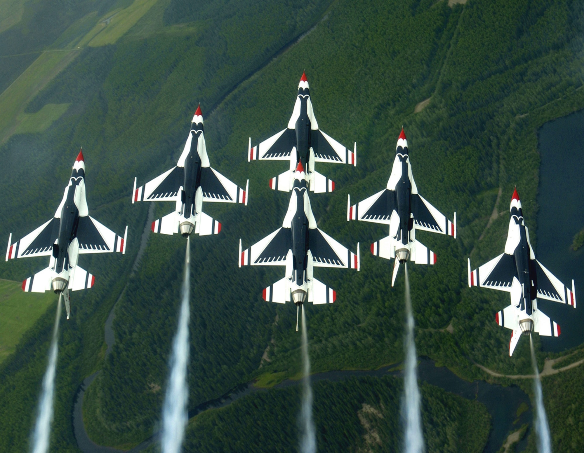 EIELSON AIR FORCE BASE, Alaska -- The Thunderbirds aerial demonstration team performs a loop while in the famous Delta formation here. The Thunderbirds fly the F-16 Fighting Falcon, a fighter that is highly maneuverable and has a proven record in combat. (U.S. Air Force photo by Tech. Sgt. Sean M. White)