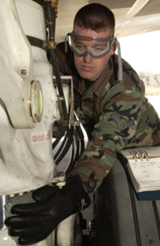 Air Force Airman 1st Class Christopher Smith wipes a B-2 Spirit landing gear strut during a pre-flight inspection at Nellis Air Force Base, Nev., on March 1, 2005. The aircraft is participating in Exercise Red Flag at Nellis. Smith is a crew chief assigned to the 509th Aircraft Maintenance Squadron, deployed from Whiteman Air Force Base, Mo., for the exercise. 