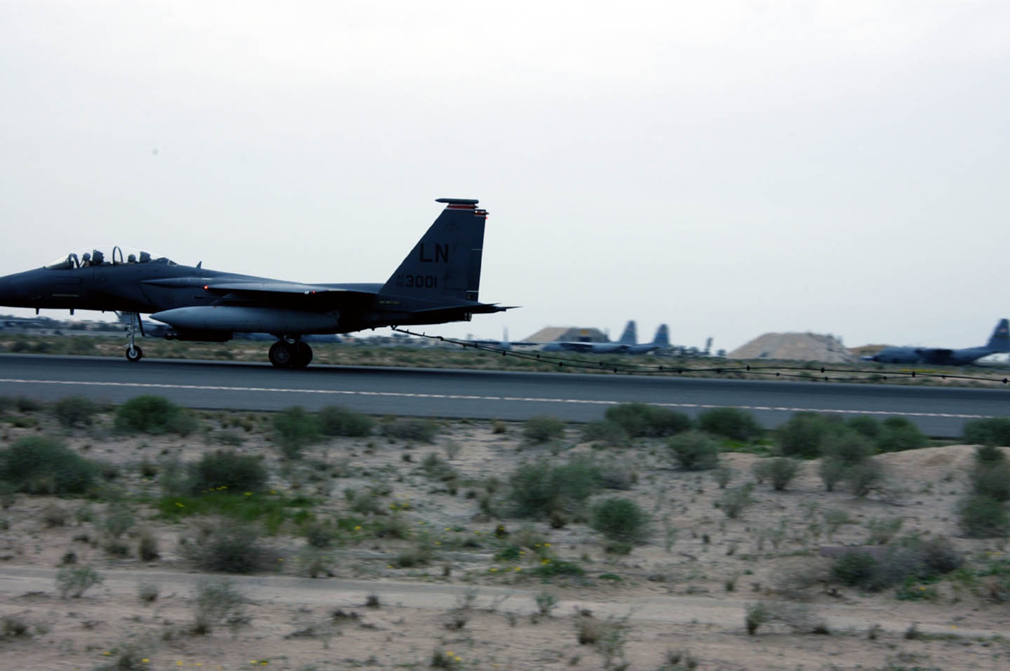 SOUTHWEST ASIA -- An F-15 Eagle is slowed from a 120 mph taxi to a stop by the mobile aircraft arresting system cable and tape which are attached to the two rotary friction energy absorber systems.  (U.S. Air Force photo by Staff Sgt. William Farrow)