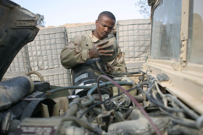 Corporal Wilfort Edmonds Jr., a mechanic from Louisville, Ky., repairs a humvee at Headquarters and Service Battalion, 2d Force Service Support Group (Forward) motor pool.  Edmonds was pulled from a provisional rifle company to perform his specific Military Occupational Specialty.  Edmonds along with five other mechanics are responsible for the maintenance of nearly 70 pieces of equipment in the motor pool.  (Photo by Cpl. C.J. Yard)