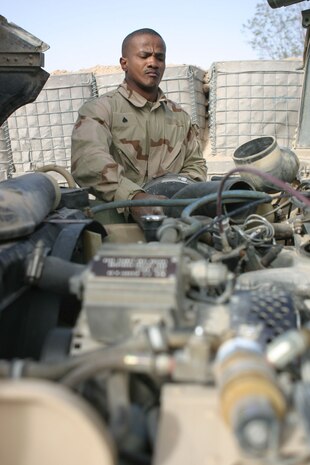 Corporal Wilfort Edmonds Jr., a mechanic from Louisville, Ky., repairs a humvee at Headquarters and Service Battalion, 2d Force Service Support Group (Forward) motor pool.  Edmonds was pulled from a provisional rifle company to perform his specific Military Occupational Specialty.  Edmonds along with five other mechanics are responsible for the maintenance of nearly 70 pieces of equipment in the motor pool.  (Photo by Cpl. C.J. Yard)