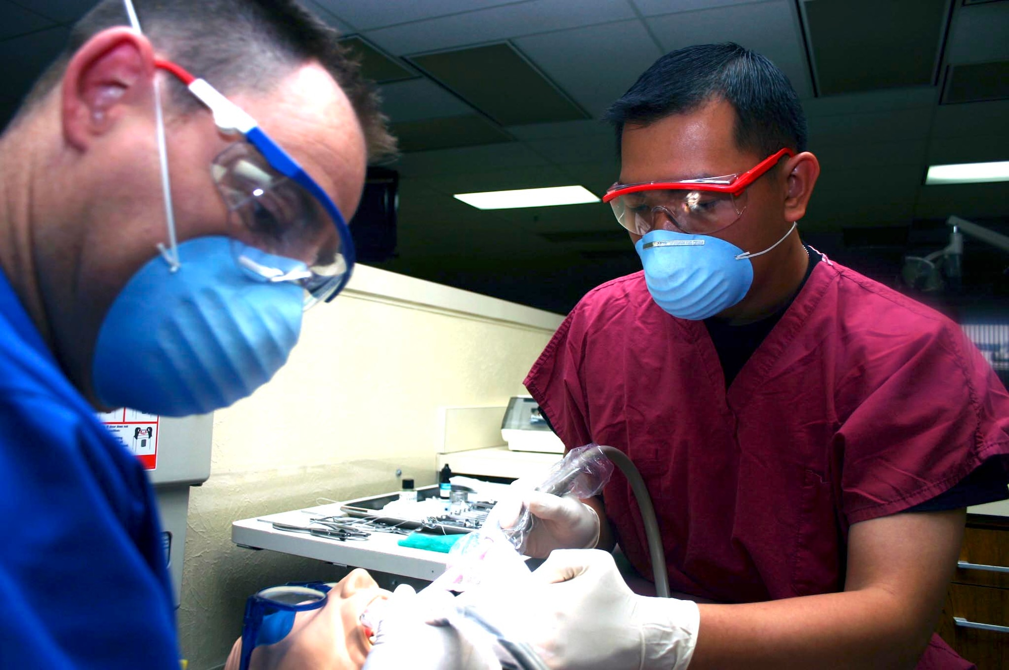 SHEPPARD AIR FORCE BASE, Texas -- Airman 1st Class Michael Dizon practices suctioning techniques under the watchful eye of his instructor, Master Sgt. Kevin Hayden.  Airman Dizon was a dentist in the Philippines, but enlisted in the Air Force to become a dental technician.  He is working toward becoming an officer and is currently assigned to the 381st Training Squadron here.  (U.S. Air Force photo by Airman 1st Class Jacque Lickteig)