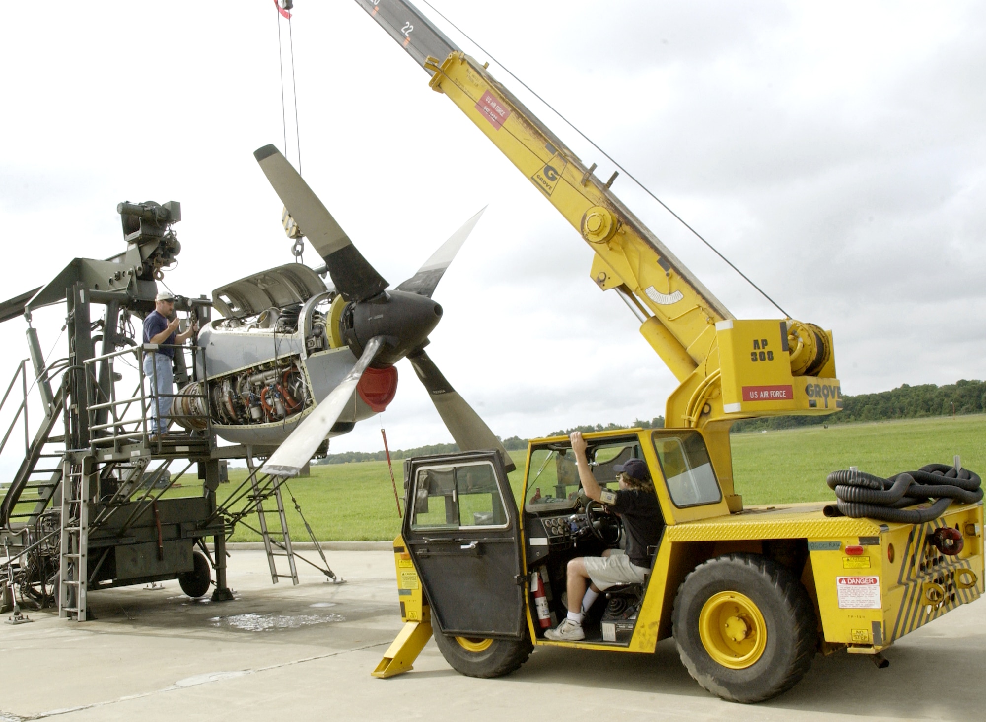 MCGUIRE AIR FORCE BASE, N.J. -- Ron Petticoffer (on test stand) and Wayne Schadler mount a C-130 Hercules engine with a modified propeller on a test stand to perform the first operational checkout of the new in-flight propeller balancing system.  The Air Mobility Battlelab here installed the new system on a C-130 assigned to the 913th Airlift Wing from Willow Grove Air Reserve Station, Pa.  The men are technicians assigned to the 913th Maintenance Group.  (U.S. Air Force photo by Staff Sgt. Tanaya Harms)