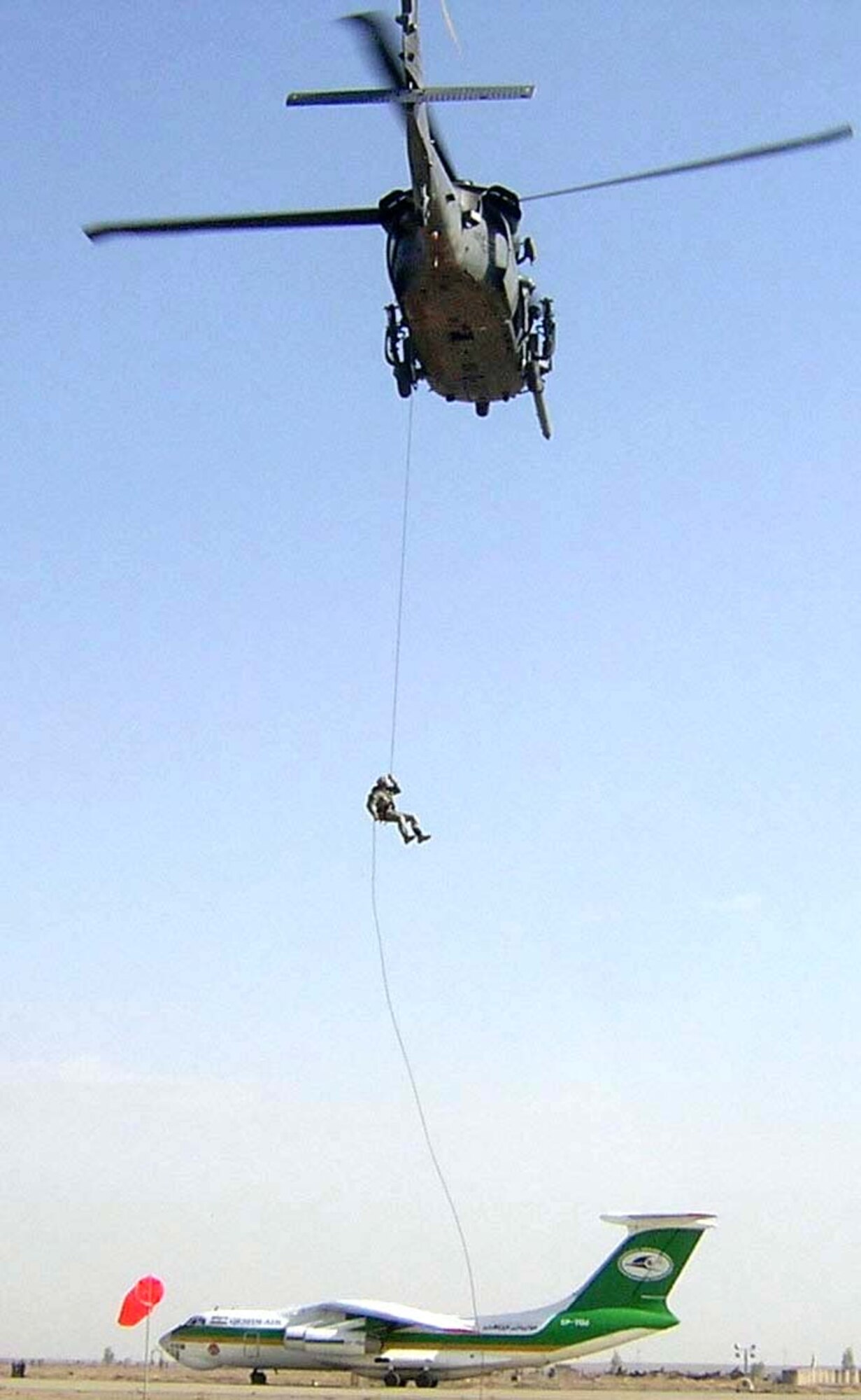KANDAHAR AIR BASE, Afghanistan -- Staff Sgt. Tan Sirisak practices rappelling from a helicopter hovering 70 feet above the airfield here.  Sergeant Sirisak is a 59th Expeditionary Rescue Squadron pararescuemen.  (Courtesy photo)