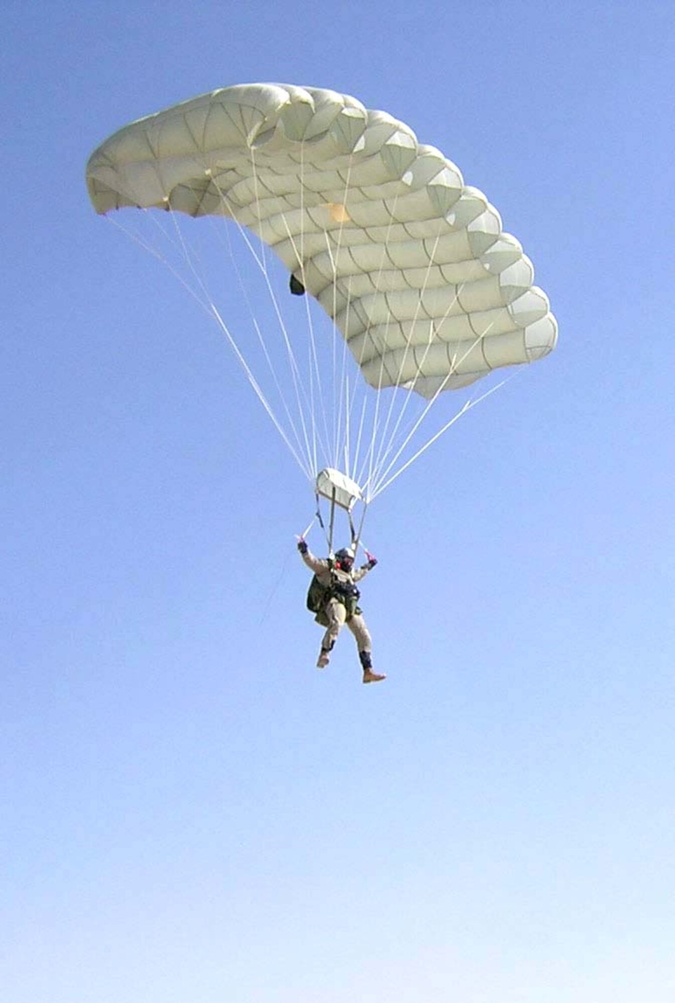 KANDAHAR AIR BASE, Afghanistan -- Senior Master Sgt. Paul Koester parachutes into the airfield here as part of a training mission.  Sergeant Koester is a 59th Expeditionary Rescue Squadron pararescuemen.  (Courtesy photo).