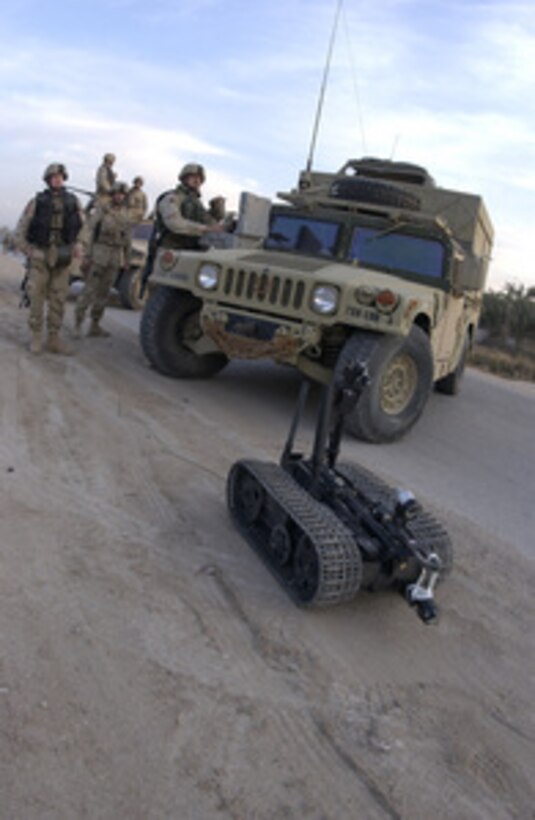 A U.S. soldier deploys a remotely controlled explosive ordnance disposal robot to detonate a possible improvised explosive device in Al Iskandariyah, Iraq, on Feb. 27, 2005. 