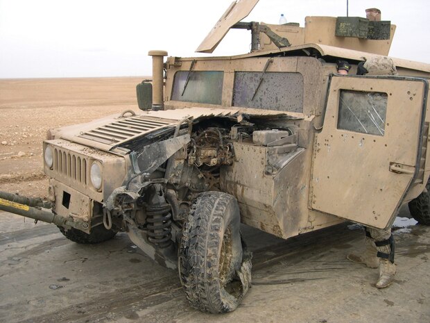 AL ASAD, Iraq - A humvee shows damage from a mine strike while on convoy in Iraq. The vehicle was in-tow when it struck the mine, and no injuries resulted from the incident. (Photo courtesy of Sgt. Rick Noble.)  -30-