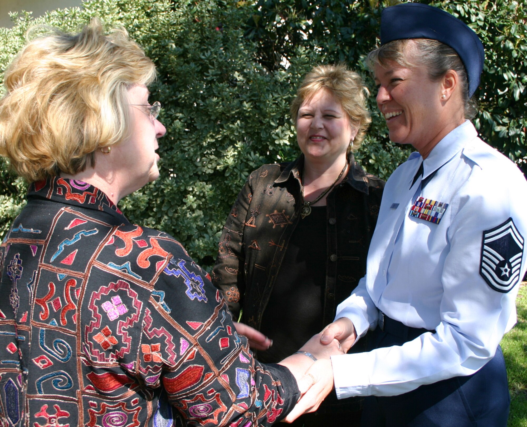 RANDOLPH AIR FORCE BASE, Texas -- Senior Master Sgt. Cheryl Wells greets Debra Morris (left) and her sister, Julia Barta.  The sisters became good friends with Sergeant Wells during a Department of Defense family member update in Houston two years ago because they wore the same "prisoner of war and missing in action" bracelets.  Sergeant Wells is a program manager at Air Force Personnel Center's missing persons branch here. (U.S. Air Force photo by Tech. Sgt. James Brabenec)