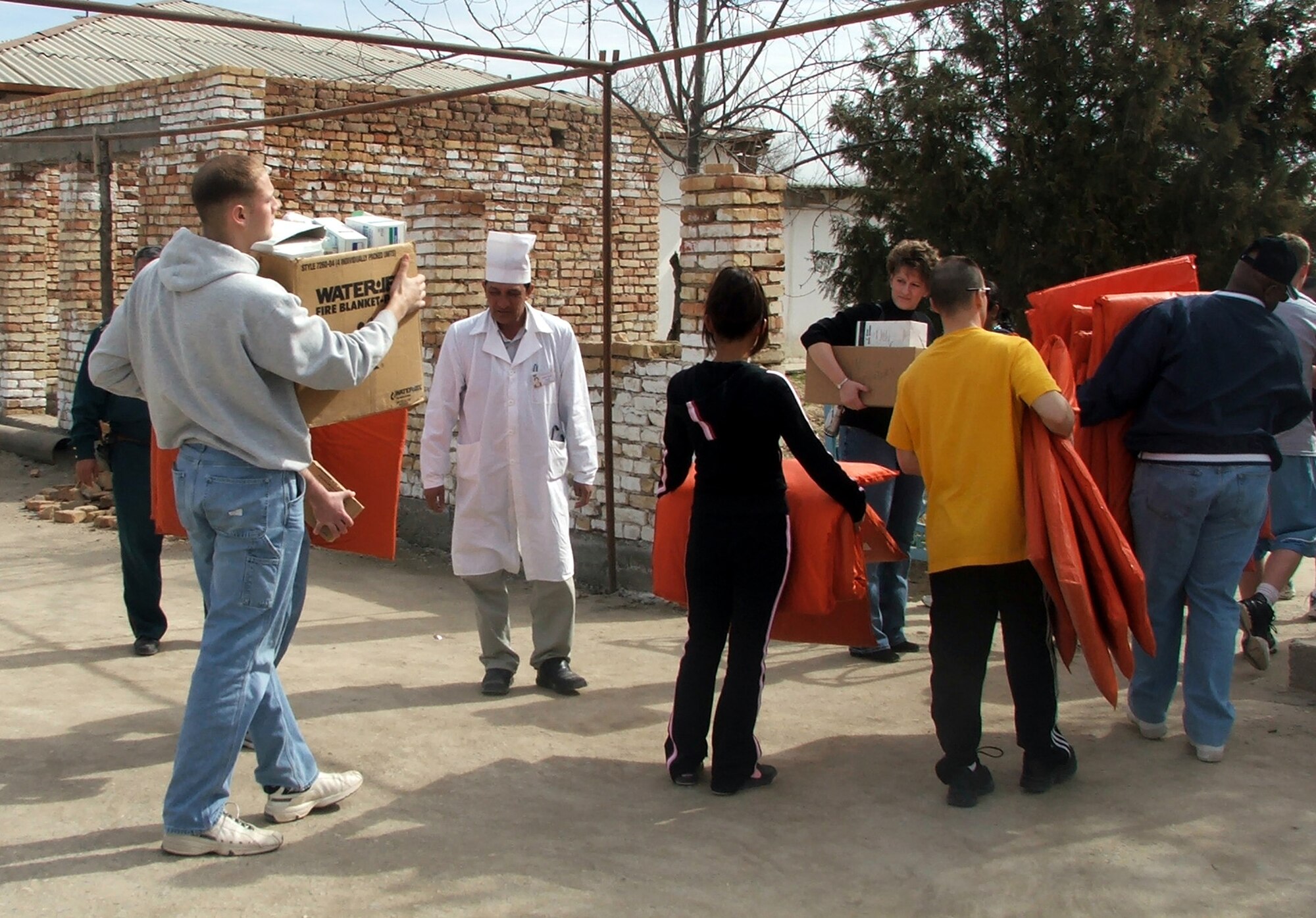 KHANABAD, Uzbekistan -- Airmen and Soldiers from nearby Karshi-Khanabad Air Base bring donated medical supplies to the local clinic during a humanitarian aid visit here March 3.  The servicemembers visited the village clinic and the school where they played a volleyball game and handed out donations.  (U.S. Air Force photo by Tech. Sgt. Scott T. Sturkol)