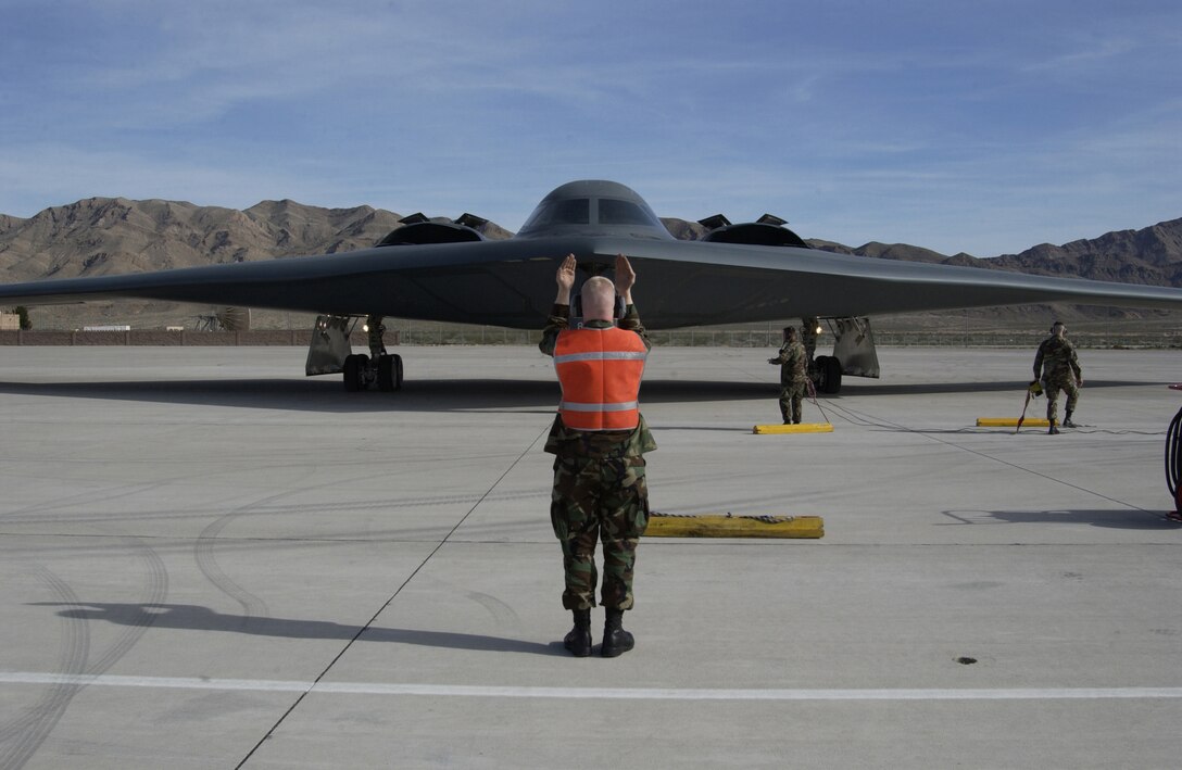 NELLIS AIR FORCE BASE, Nev. -- Airman 1st Class Richard Maure marshals in a B-2 Spirit after a Red Flag 2005 mission here March 1. Airman Maure is a crew chief with the  509th Aircraft Maintenance Squadron and the B-2 is assigned to the 509th Bomb Wing at Whiteman AFB, Mo. (U.S. Air Force photo by Tech. Sgt. Roy A. Santana)