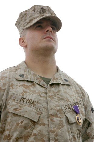 CAMP TAQADDUM, Iraq (March 11, 2005) - Corporal Stephen A. Reyna, a Marine with 6th Engineer Support Company, receives a Purple Heart from Brig. Gen. Andrew B. Davis, 4th Force Service Support Group Commanding General, during a ceremony held here March 9. Reyna, a 25-year-old Grand Rapids, Mich., native's vehicle was hit by a vehicle born improvised explosive device when returning from Operation Phantom Fury November 8.   The vehicle was severely damaged by the IED blast and immediately burst into flames. Reyna received minor wounds. Reyna is attached to the West Coast-based 1st FSSG in support of Operation Iraqi Freedom and prepares to return home after serving more than six months in Iraq. (Photo by Sgt. Kristin S. Jochums)