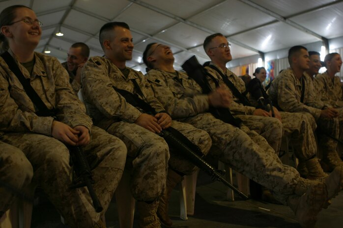 Marines laugh at the jokes of comedian Steve Byrne.  Byrne and other comedians Colin Quinn and Robert Kelley provided a night of laughs for the men and women fighting the Global War on Terrorism.  The comedians were brought to Camp Taqaddum, Iraq as part of a ten-day tour sponsored by the United Services Organization and Armed Forces Entertainment.  (Photo by Cpl. C.J. Yard)