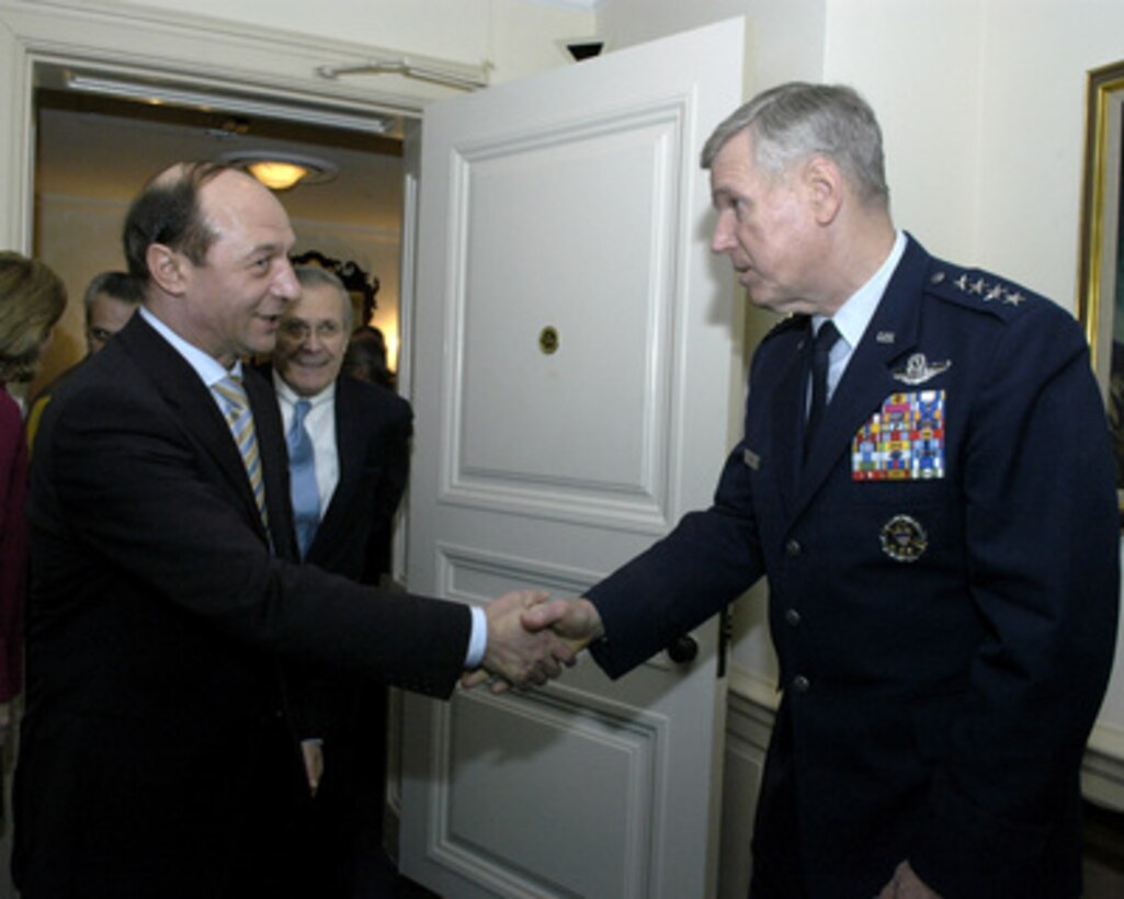 Secretary of Defense Donald H. Rumsfeld (center) introduces Romanian President Traian Basescu (left) to Chairman of the Joint Chiefs of Staff Gen. Richard B. Myers, U.S. Air Force, (right) in the Pentagon on March 9, 2005. The leaders are meeting to discuss defense issues of mutual interest. 