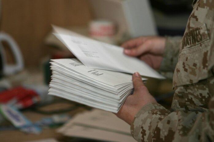 CAMP TAQADDUM, Iraq (March 11, 2005) - The post office here prints nearly 700 MotoMails daily. The 24 Marines with 2d Force Service Support Group (Forward) postal route the MotoMail and parcels to the thousands of service members serving throughout western Iraq. (Photo by Sgt. Kristin S. Jochums)