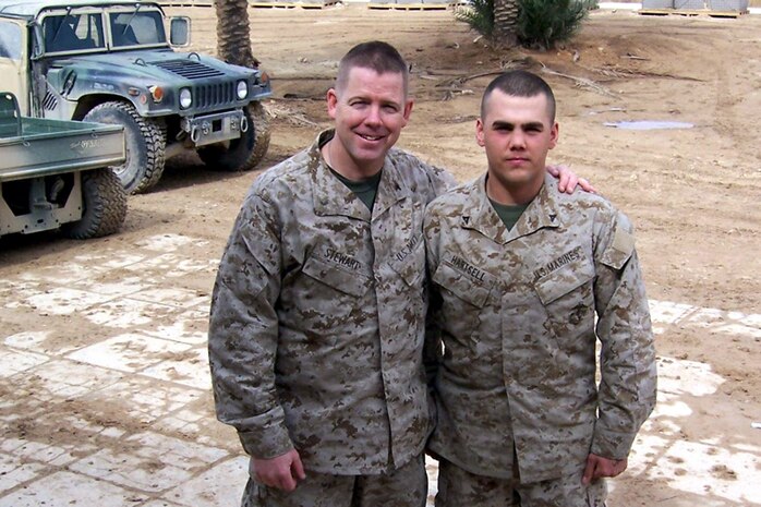 Lt. Cmdr. Ray Stewart, chaplain for Marine Air Control Group 28 and Lance Cpl. Chase R. Hartsell, a tactical network systems specialist assigned to 2nd Force Service Support Group’s Combat Logistics Battalion 2 pose for a phtograph here.  Stewart and Hartsell were reunited here.  They had not seen each other since 1997.