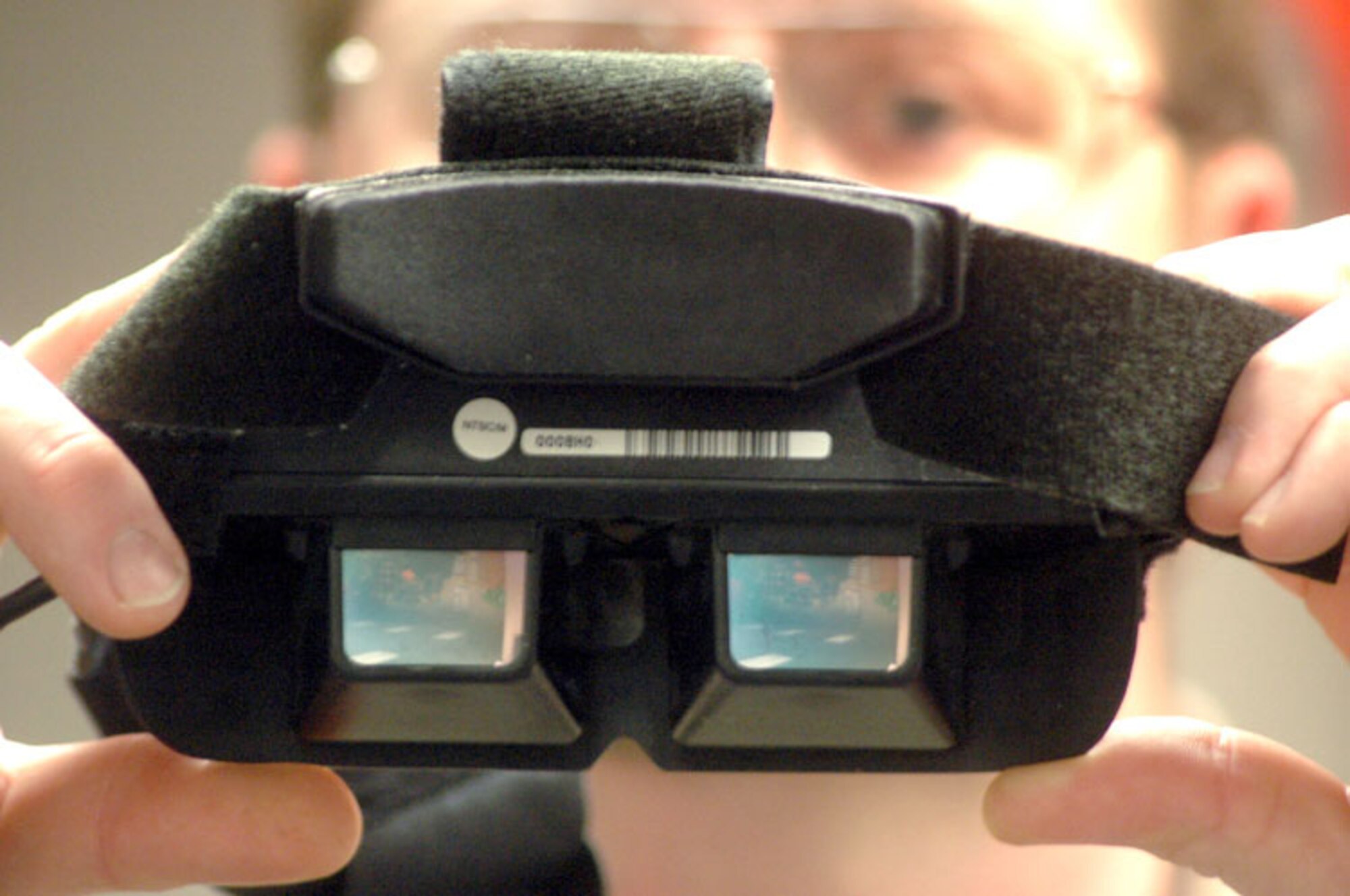 ROBINS AIR FORCE BASE, Ga. -- Dave Dawson holds special training goggles that use virtual reality to simulate a parachute jump for the person wearing them.  Mr. Dawson is a continuation training specialist with the 19th Air Refueling Group here.  (U.S. Air Force photo by Sue Sapp)