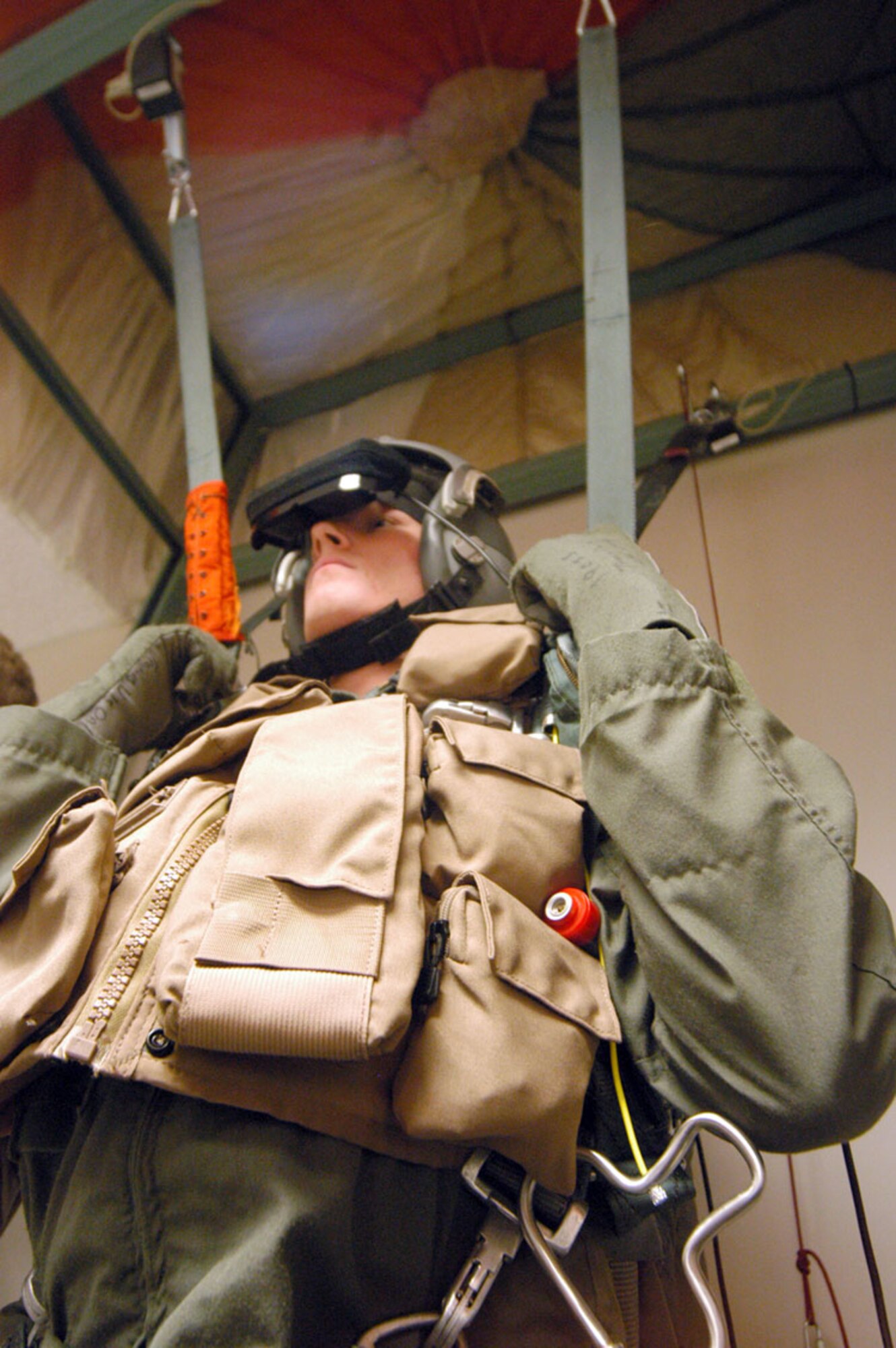 ROBINS AIR FORCE BASE, Ga. -- Airman 1st Class Zach Lauritzen hangs from the harness trainer during his "jump."  Airman Lauritzen, a KC-135 Stratotanker boom operator, was taking a parachuting refamiliarization class.  (U.S. Air Force photo by Sue Sapp)