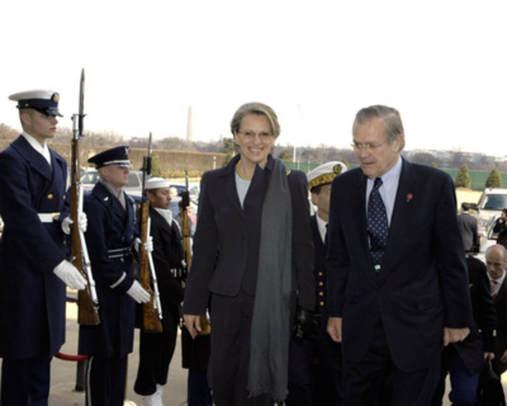 French Minister of Defense Michelle Alliot-Marie (left) is escorted through an honor cordon and into the Pentagon by Secretary of Defense Donald H. Rumsfeld on March 9, 2005. Alliot-Marie and Rumsfeld will meet to discuss defense issues of mutual interest. 