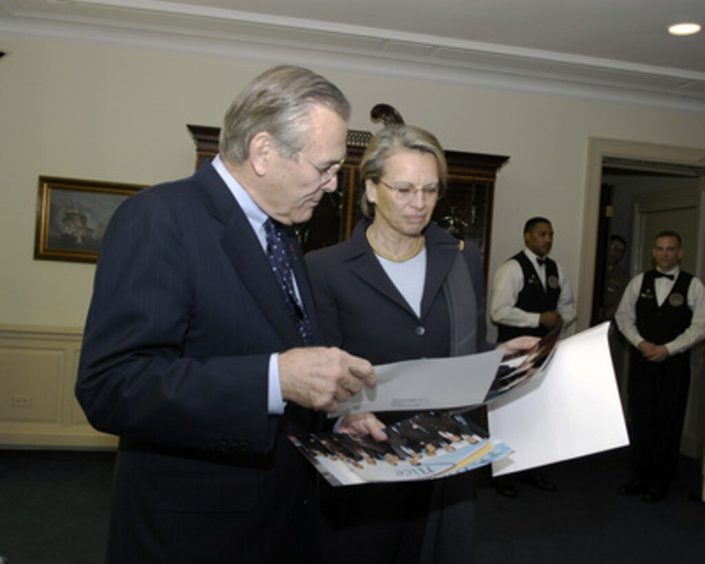 French Minister of Defense Michelle Alliot-Marie (right) presents Secretary of Defense Donald H. Rumsfeld photographs on March 10, 2005, from the NATO Defense Ministerial Conference that was held in Nice, France. Alliot-Marie and Rumsfeld will meet to discuss defense issues of mutual interest. 