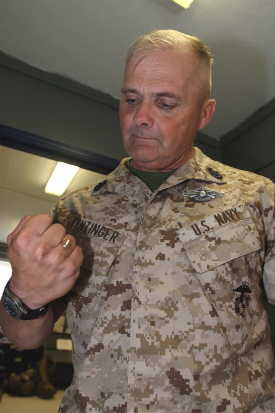 AL ASAD, Iraq -- Staff Sgt. Roger W. King, helicopter mechanic assigned to Marine Light/Attack Helicopter Squadron 269 and Gravette, Ark., native, reinstalls the tunnel cowling of a UH-1N Huey after daily and turnaround inspections of the tail rotor driveshaft.  King recently re-enlisted and will make a lateral move to become an MV-22 Osprey flight line mechanic.