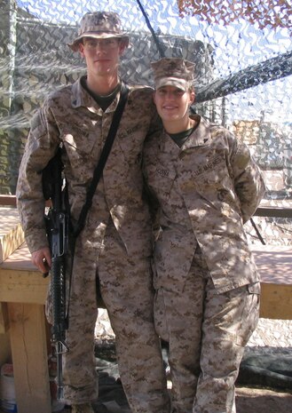 CAMP TAQADDUM, Iraq -- Cpls. Michael D. and Nicole L. Hodina stand for a photo while deployed here.  Michael, noncommissioned officer in charge of special products at the Supply Management Unit and Nicole is a procurement specialist for the SMU, Combat Logistics Regiment 25, 2d Force Service Support Group (Forward).  Nicole is a native of Steen, Minn., and Michael hails from Indianapolis.