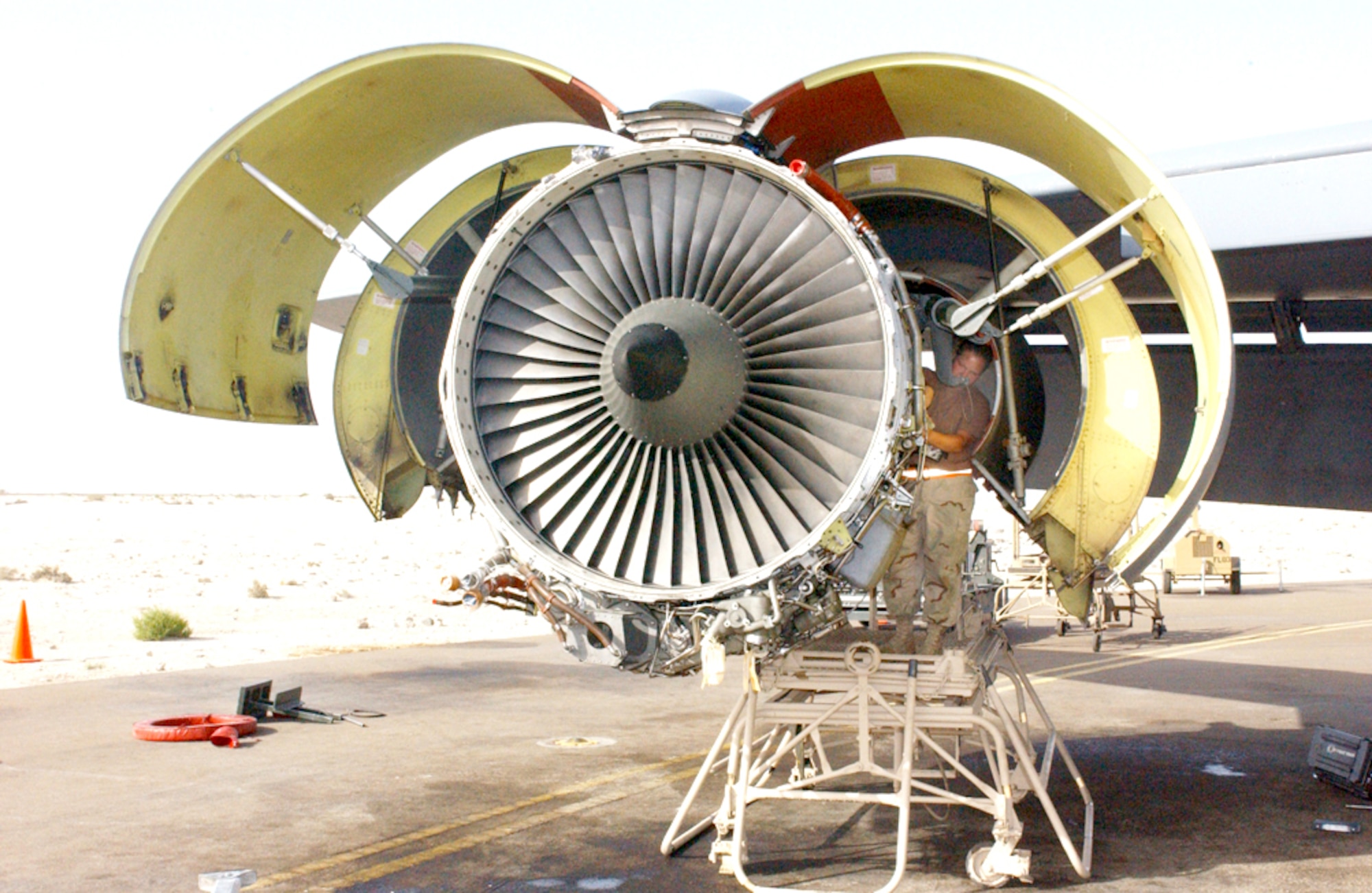 SOUTHWEST ASIA -- Senior Airman Abby Hernandez reconnects components of a KC-135 Stratotanker engine that was just installed.  KC-135 engines rarely go through an engine swap, but maintainers at a forward-deployed location recently had to replace an engine on two KC-135s in the span of about a week.   Airman Hernandez is deployed with the 380th Expeditionary Aircraft Maintenance Squadron.  (U.S. Air Force photo by Airman 1st Class Bruce Hedrick) 