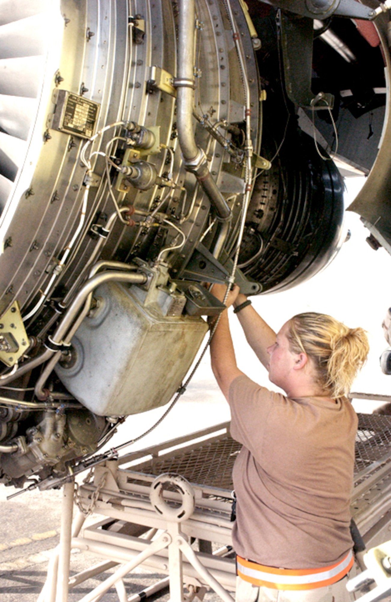 SOUTHWEST ASIA -- Senior Airman Abby Hernandez reconnects components of a KC-135 Stratotanker engine that was just installed.  KC-135 engines are very reliable and rarely have to be swapped.  But Airmen at a forward-deployed location recently had to replace an engine on two KC-135s in the span of about a week.  Airman Hernandez is deployed with the 380th Expeditionary Aircraft Maintenance Squadron.  (U.S. Air Force photo by Airman 1st Class Bruce Hedrick) 