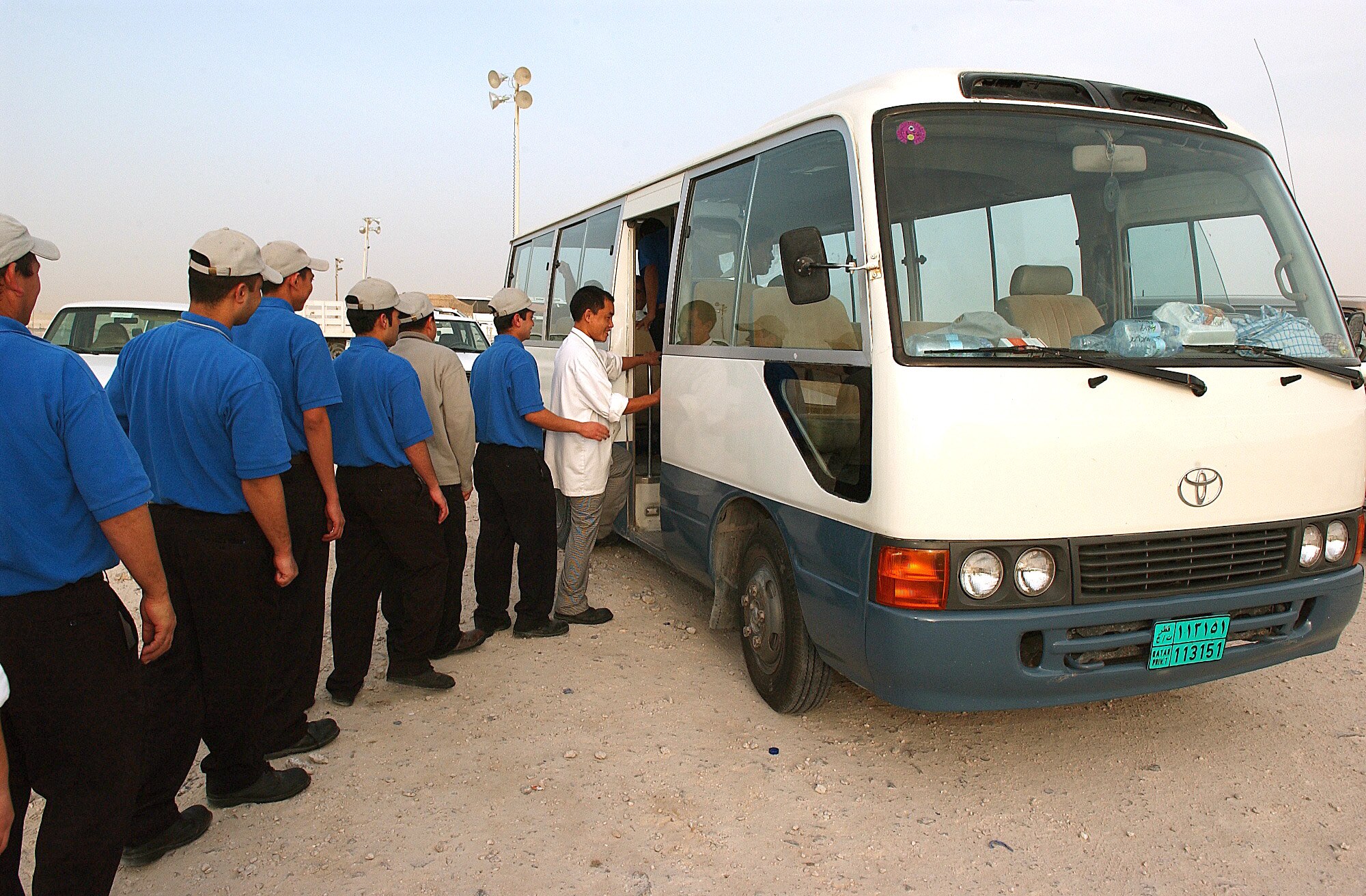 SOUTHWEST ASIA -- Foreign workers board a bus.  (U.S. Air Force photo by Staff Sgt. Colette Bennett) 
