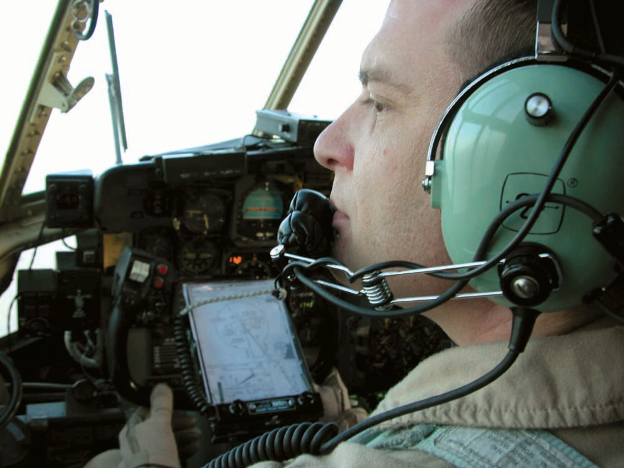 AIRBORNE -- Maj. Thomas Huzzard looks out a window of a C-130 Hercules during a flight from Djibouti to Seychelles.  Major Huzzard is a 746th Expeditionary Airlift Squadron pilot and the mission commander.  (U.S. Air Force photo by Senior Airman Karah Manning)
