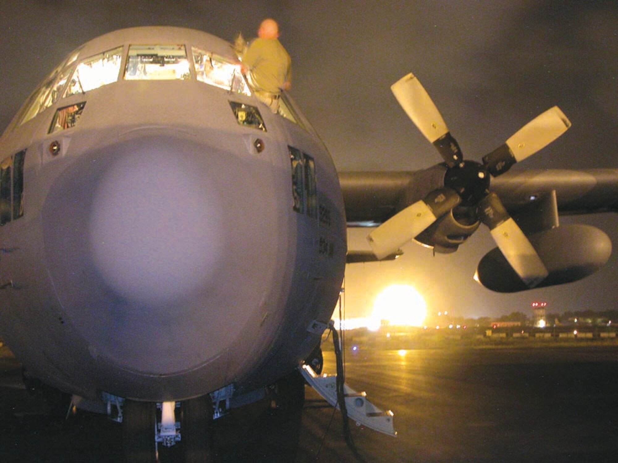 DJIBOUTI -- Tech. Sgt. Matthew Davis washes the pilot-side window before a six-plus-hour flight from here to the Seychelles Islands.  He is a 379th Expeditionary Aircraft Maintenance Squadron C-130 Hercules crew chief.  (U.S. Air Force photo by Senior Airman Karah Manning)
