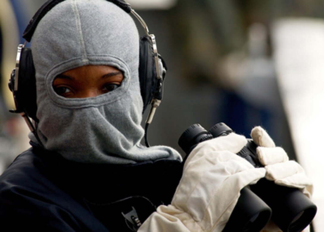 Seaman Angel Hilton stands a force protection watch on the signal bridge during a general quarters drill aboard the aircraft carrier USS Harry S. Truman (CVN 75) on March 8, 2005. The Truman and its embarked Carrier Air Wing 3 are providing close air support and conducting intelligence surveillance and reconnaissance over Iraq. Hilton is a Navy Operations Specialist. 