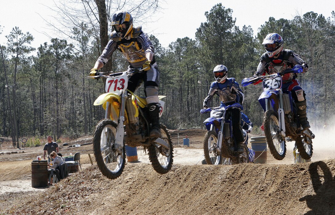 Sgt. Craig Cloud, ordnance, Marine Attack Training Squadron 203, Sgt. Sherdon Valentine, airframer, Marine Attack Squadron 223, and Capt. William Klumpp III, public affairs officer, 26th Marine Expeditionary Unit, take off during the second race of the day at the Motocross spring series opener at Half Moon MX Park. Valentine and Cloud are members of Cherry Point's Full Throttle Racing team.