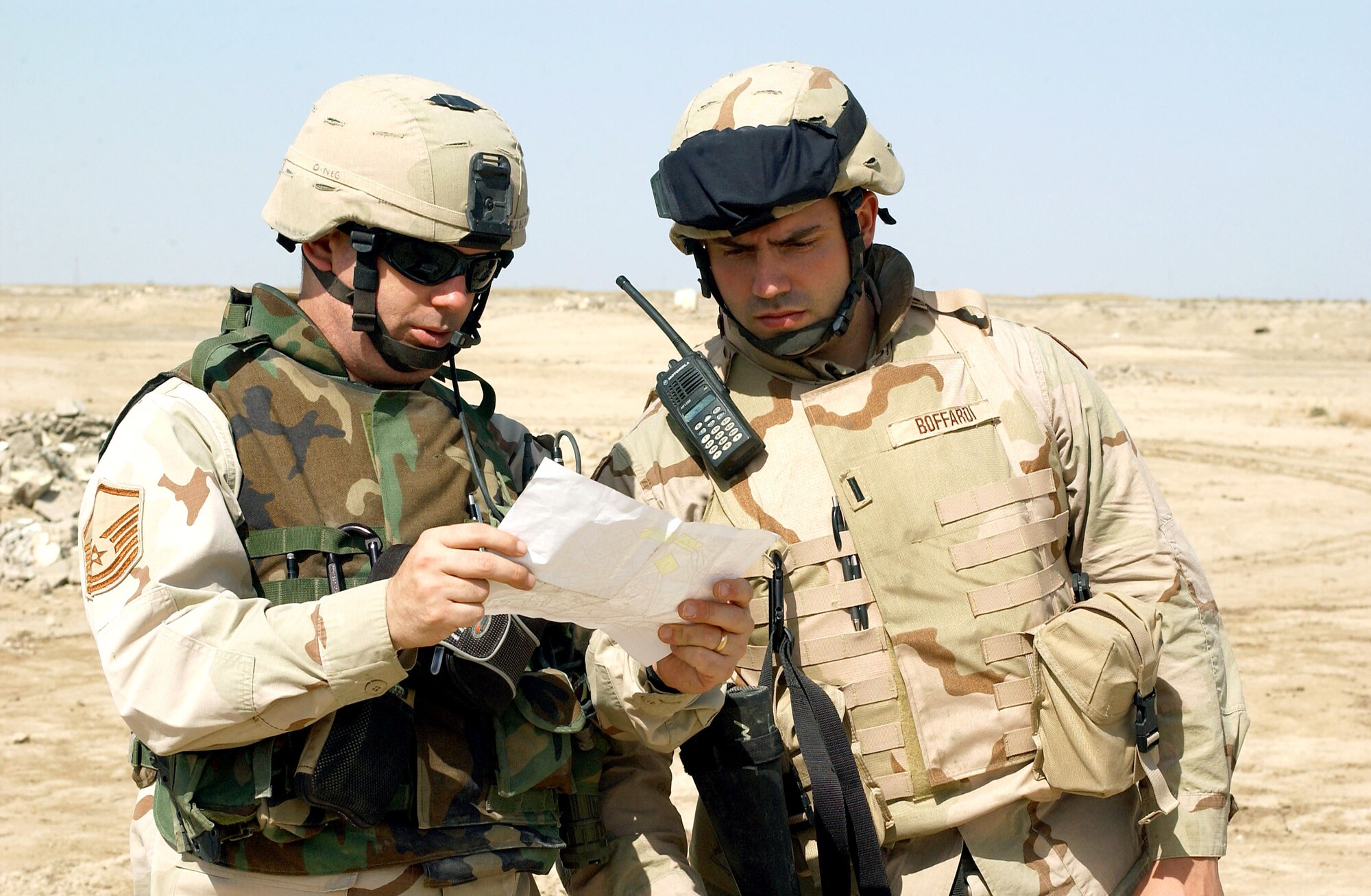 NEAR TALLIL AIR BASE, Iraq -- Master Sgt. John Ragland (left) discusses the next stop on a visit to Bedouin camps here with Army 1st Lt. Damien Boffardi. Sergeant Ragland is assigned to the 407th Security Forces Squadron, and Lieutenant Boffardi is assigned to the 484th Movement Control Battalion.  (U.S. Air Force photo by Master Sgt. Mark Bucher) 