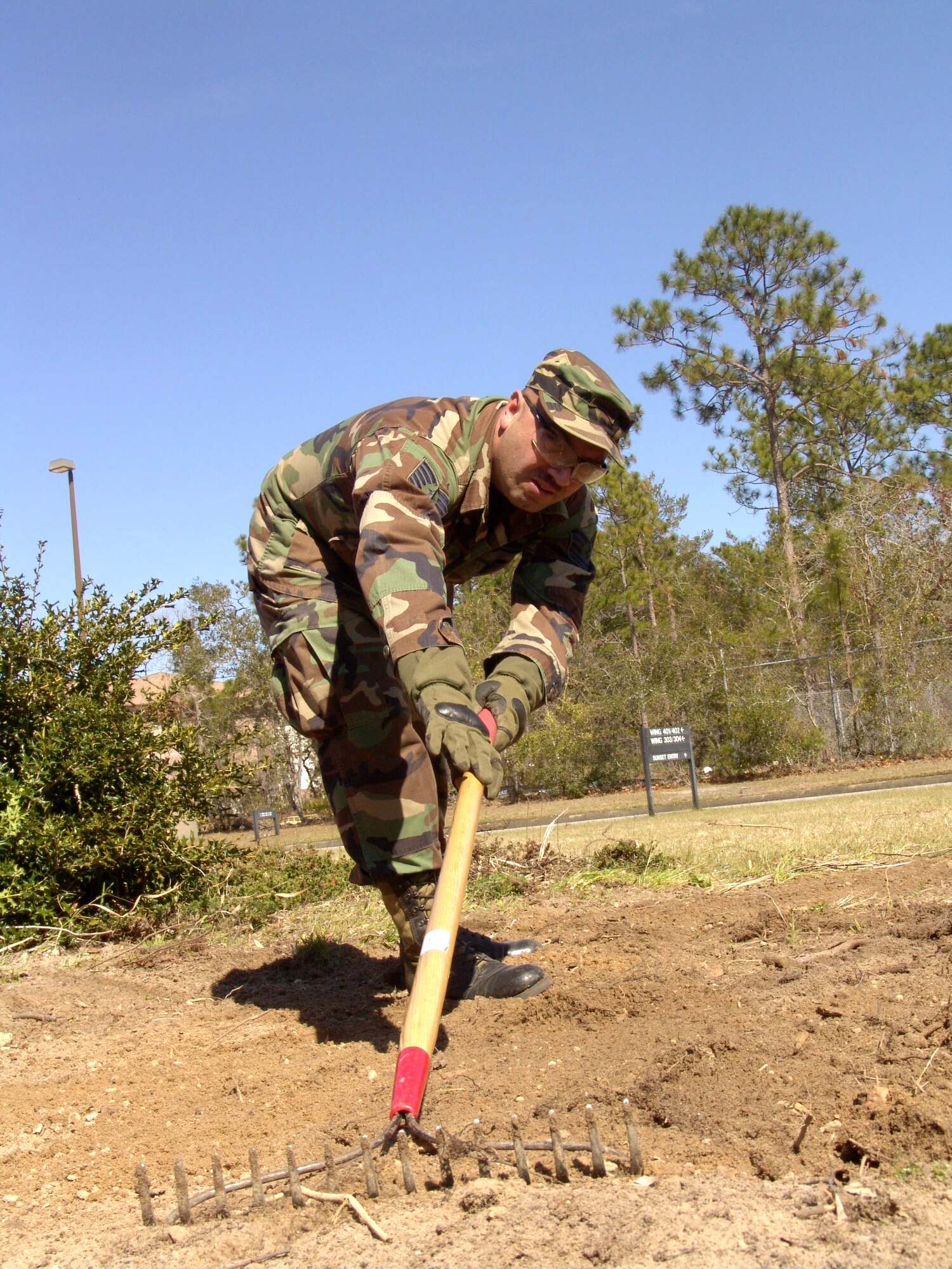 SHALIMAR, Fla. -- Tech. Sgt. James Trefurt levels the ground where a stump was removed.  The tree fell on the side of a house at Bob Hope Village here.  He and other instructors with the 96th Ground Combat Training Squadron at nearby Eglin Air Force Base cut up fallen trees and pulled 18 stumps, saving the village more than $2,000.  Hurricane Ivan downed hundreds of trees on the property and caused more than $300,000 in damage.  (U.S. Air Force photo by Senior Airman Mike Meares)