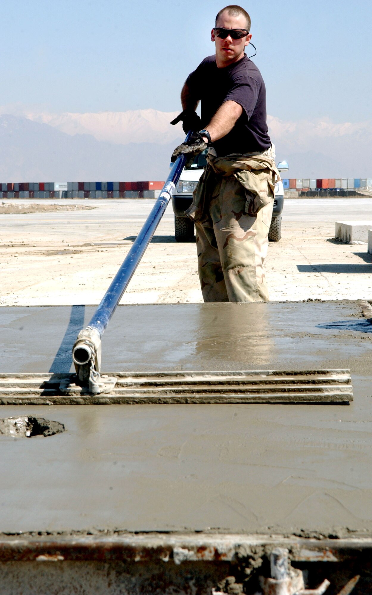 BAGRAM AIR BASE, Afghanistan -- Staff Sgt. Chad Walter finishes the concrete on one of the 28 precast runway replacement slabs destined for the 9,800-foot runway here.  He is assigned to the 455th Expeditionary Civil Engineer Squadron.  (U.S. Air Force photo by Capt. Catie Hague) 
