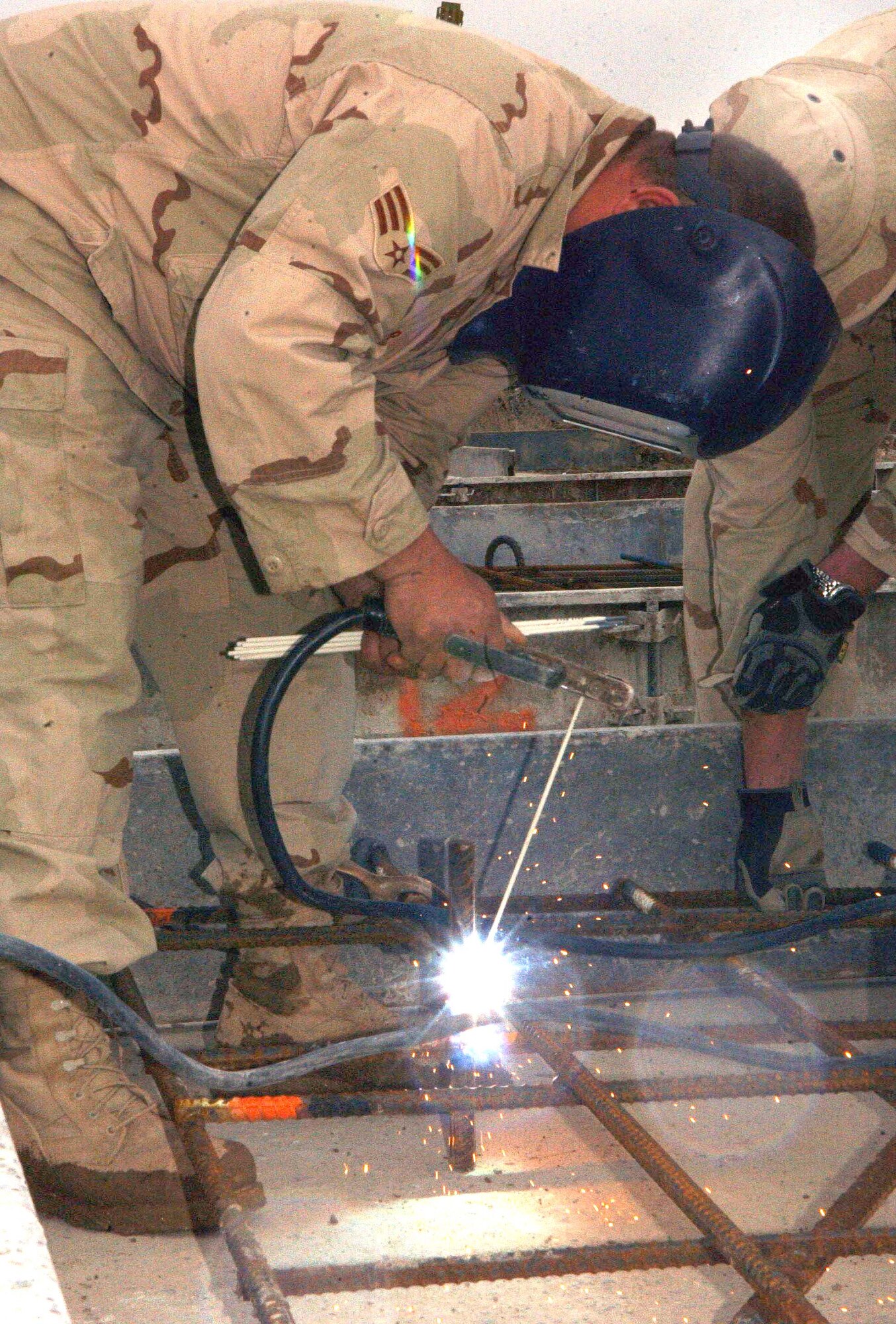 BAGRAM AIR BASE, Afghanistan -- Senior Airman Chris Bender welds the forms for runway replacement slabs.  Twenty-eight deteriorating runway slabs are scheduled to be replaced over 16 weeks here.  He is assigned to the 455th Expeditionary Civil Engineer Squadron.  (U.S. Air Force photo by Capt. Catie Hague) 