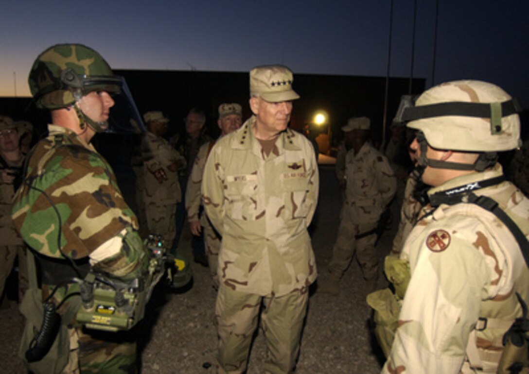 Chairman of the Joint Chiefs of Staff Gen. Richard B. Myers (center), U.S. Air Force, talks to soldiers with the 3rd Infantry Division after they gave him a demonstration on their latest mine detecting technology at Camp Victory, Iraq, on March 14, 2005. Myers is traveling throughout Iraq to talk to the senior leadership and the troops deployed there. 