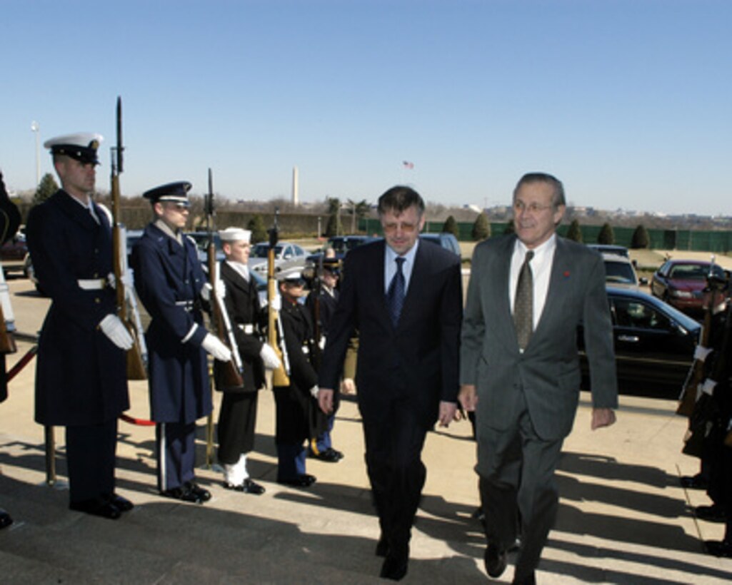 Secretary of Defense Donald H. Rumsfeld (right) escorts Lithuanian Minister of Defense Gediminas Kirkalas (left) through an honor cordon and into the Pentagon on March 15, 2005. Rumsfeld and Kirkalas will meet to discuss defense issues of mutual interest. 