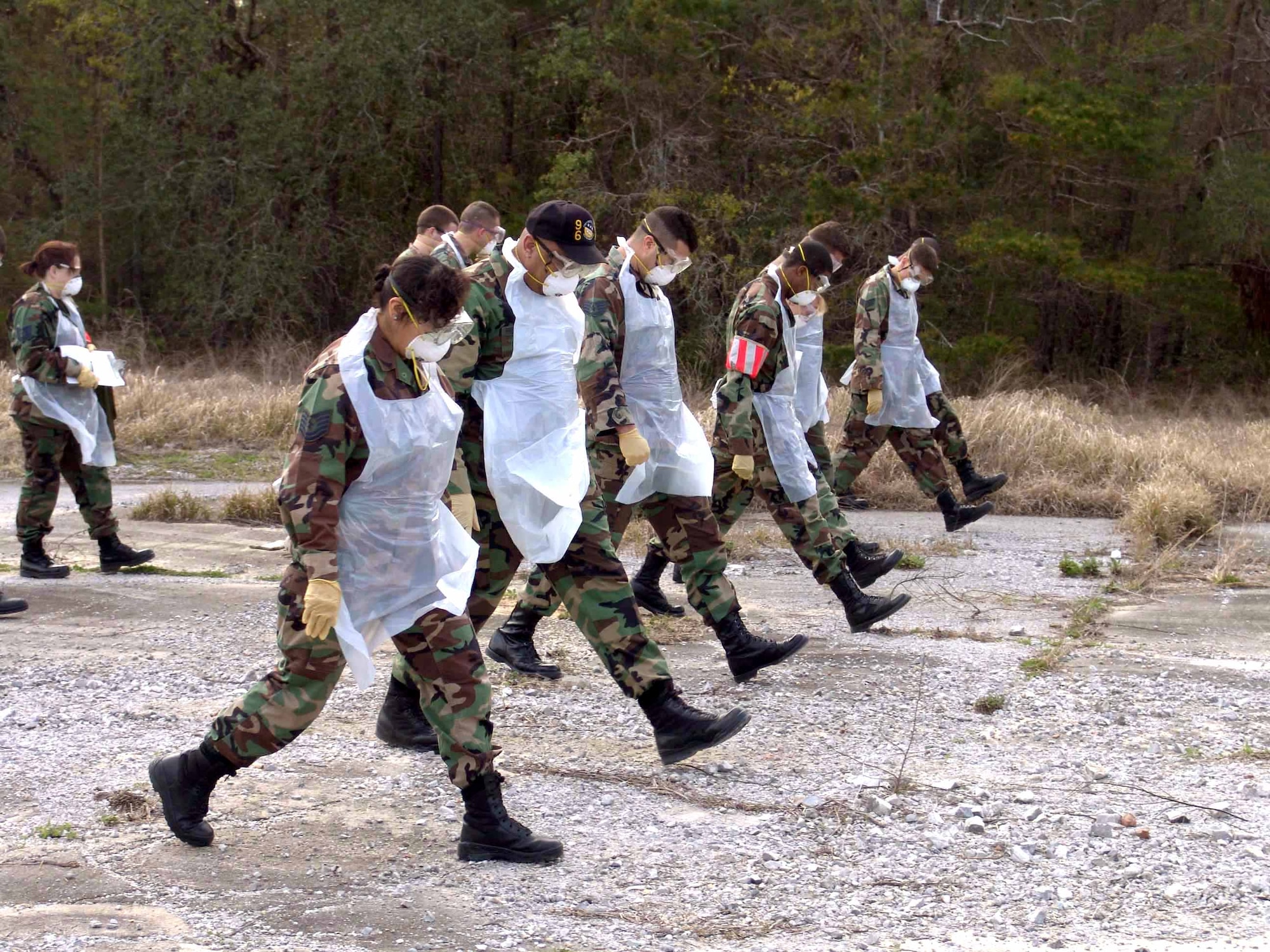 EGLIN AIR FORCE BASE, Fla. -- A search and recovery team methodically walks across a search area one step at a time looking for anything out of place during a training exercise here.  The team is made up of at least 26 Airmen who strive to find anything out of place in the aftermath of an accident. (U.S. Air Force photo by Senior Airman Mike Meares) 