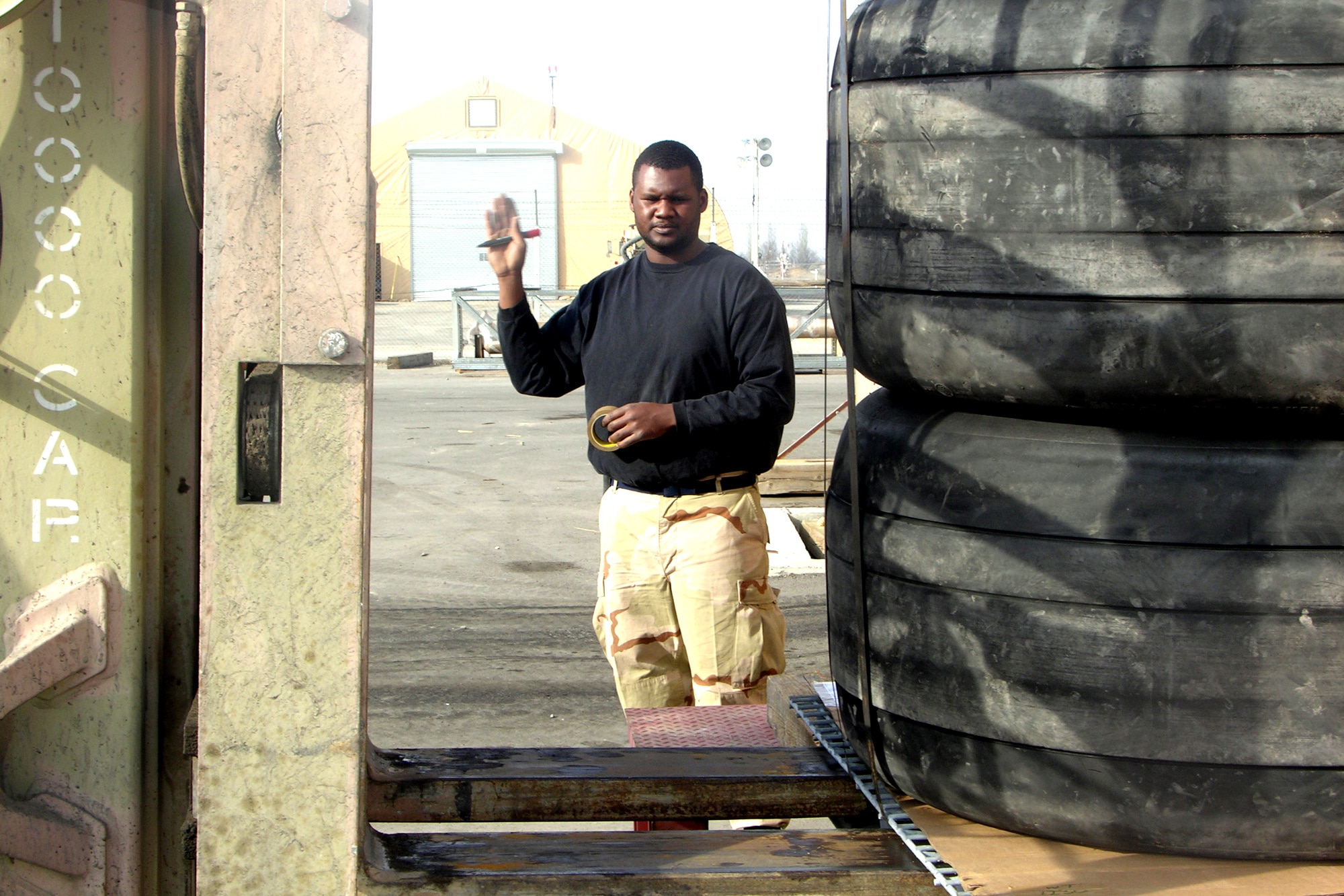 MANAS AIR BASE, Kyrgyzstan -- Staff Sgt. DeAndre Taylor guides a 10K-loader onto scales to check the weight of cargo.  In one week, Traffic Management Office Airmen moved more than 500,000 pounds of cargo.  (U.S. Air Force photo by Staff Sgt. J. Russell Martin)
