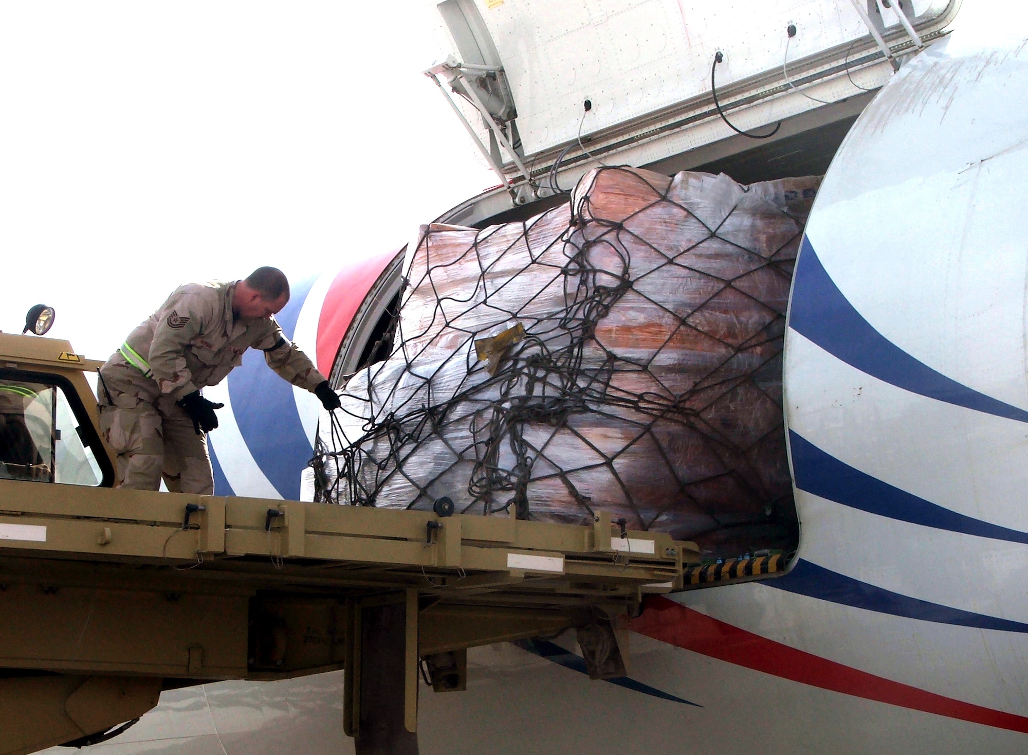 KARSHI-KHANABAD AIR BASE, Uzbekistan -- Tech. Sgt. Bringham Norman helps move a pallet filled with mail here recently.  He is an air transportation craftsman with the 416th Expeditionary Mission Support Squadron's Air Terminal Operations Center from Maxwell Air Force Base, Ala.  (U.S. Air Force Photo by Tech. Sgt. Scott T. Sturkol)    
