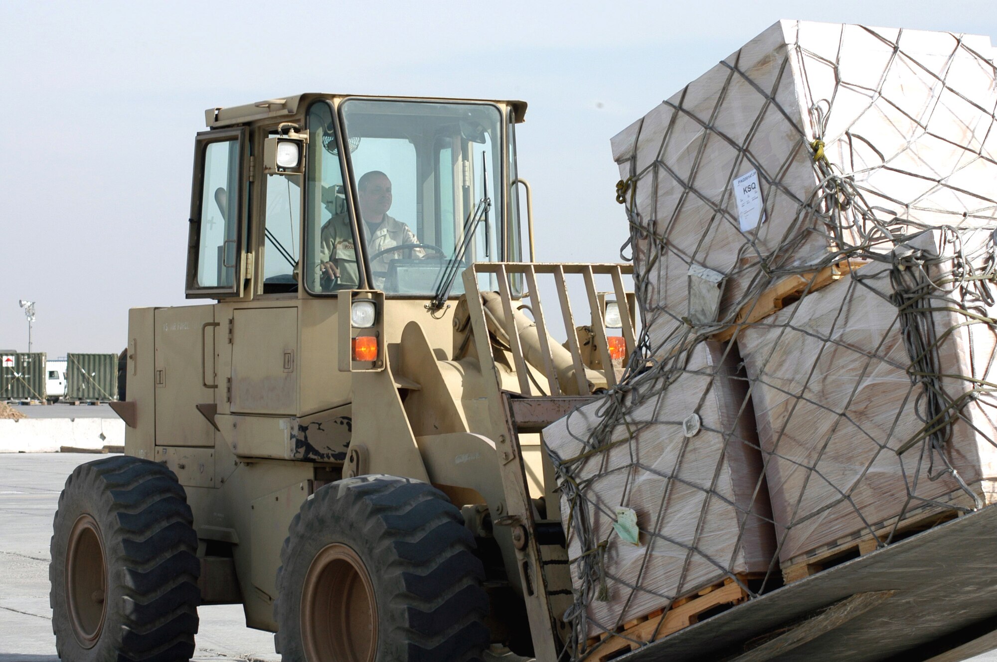 KARSHI-KHANABAD AIR BASE, Uzbekistan -- Master Sgt. Johnny Poole uses a forklift to pick up cargo from a plane here recently.  He is an air transportation craftsman with the 416th Expeditionary Mission Support Squadron's Air Terminal Operations Center deployed from Robins Air Force Base, Ga. (U.S. Air Force Photo by Tech. Sgt. Scott T. Sturkol)