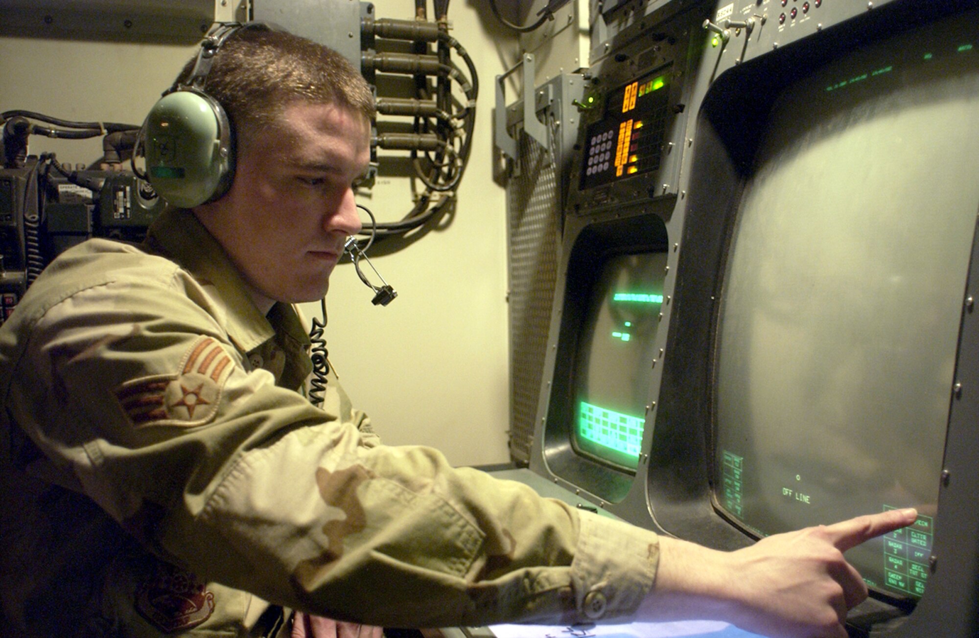BALAD AIR BASE, Iraq -- Senior Airman William Swanson monitors Iraqi theater operations from an operator console.  He is a 727th Expeditionary Air Control Squadron surveillance technician.  (U.S. Air Force photo by Staff Sgt. Neal Joiner)