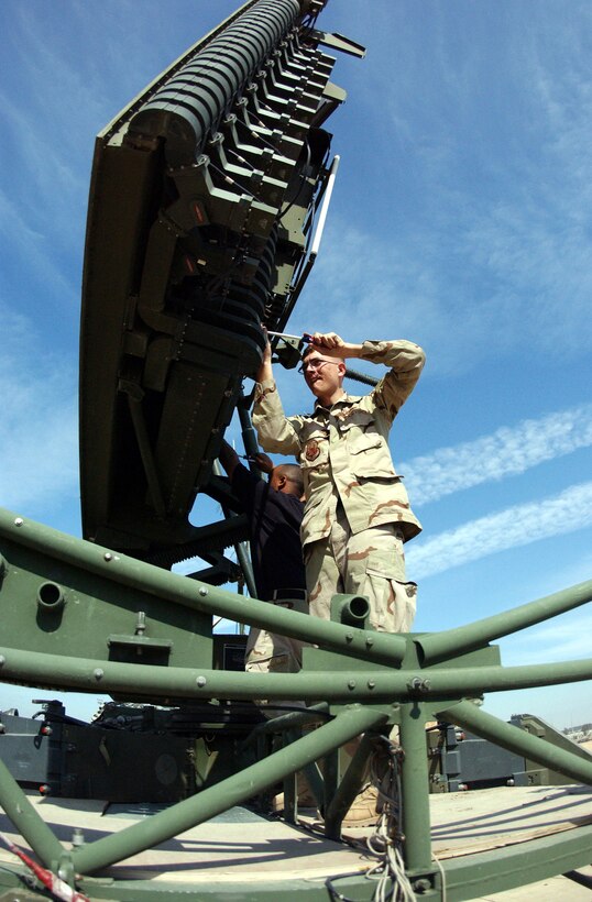 BALAD AIR BASE, Iraq -- Staff Sgt. Jacob Getzelman (front) and Senior Airman Ronald Adair open a panel in a radar antenna to align the radio frequency receiver.  The alignment is critical to radar height accuracy.  The Airmen are 727th Expeditionary Air Control Squadron ground radar systems journeymen.  (U.S. Air Force photo by Staff Sgt. Lindsey Maurice)