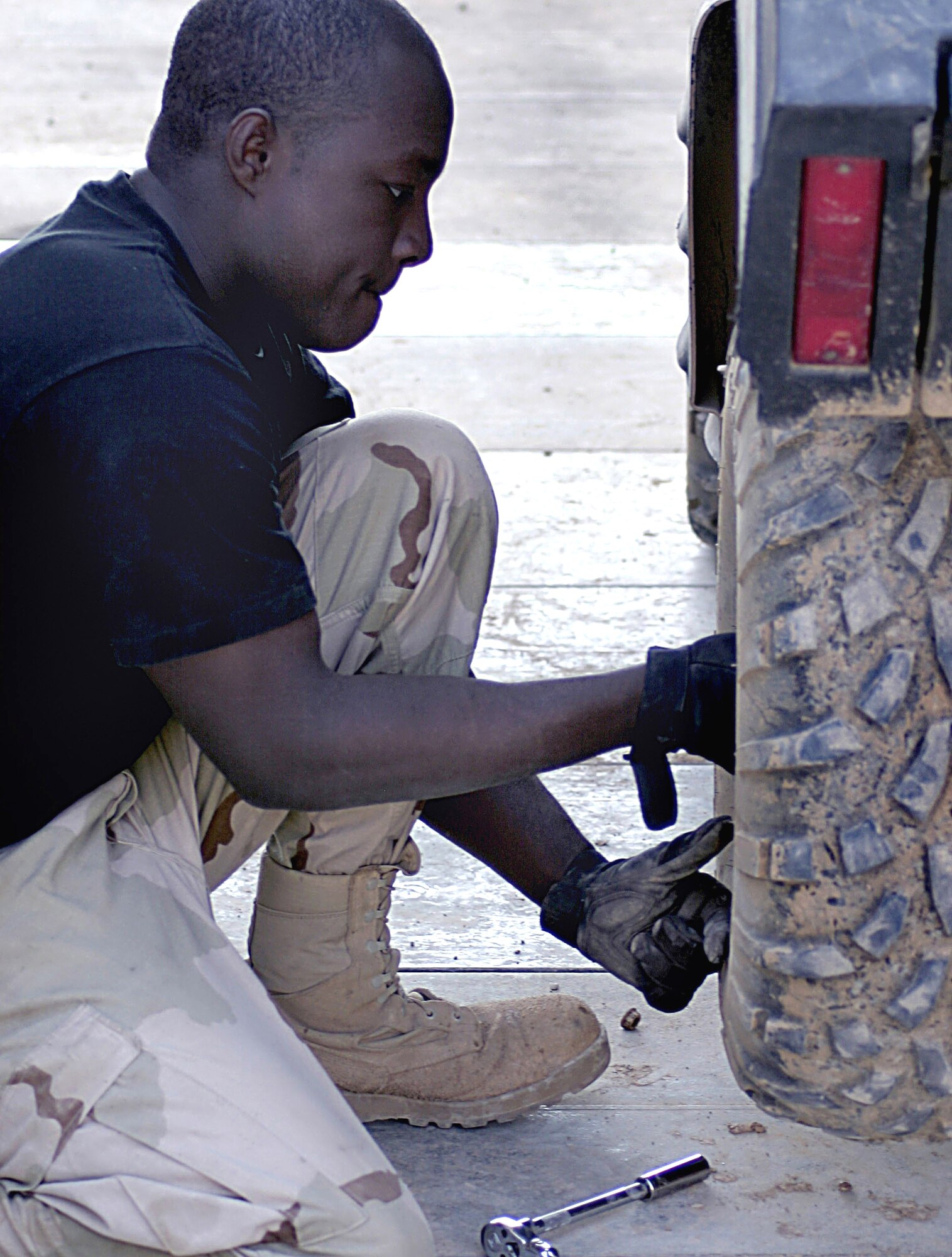 BALAD AIR BASE, Iraq -- Airman 1st Class Dayson Lee changes a wheel bearing on a vehicle.  He is a 727th Expeditionary Airlift Control Squadron vehicle and equipment maintenance journeyman.  (U.S. Air Force photo by Senior Airman Adam Bradford) 