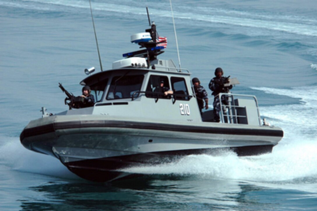 A patrol craft from Inshore Boat Unit 24 makes a hard turn to starboard as the crew conducts a security patrol in the waters near the Kuwait Naval Base on March 3, 2005. 