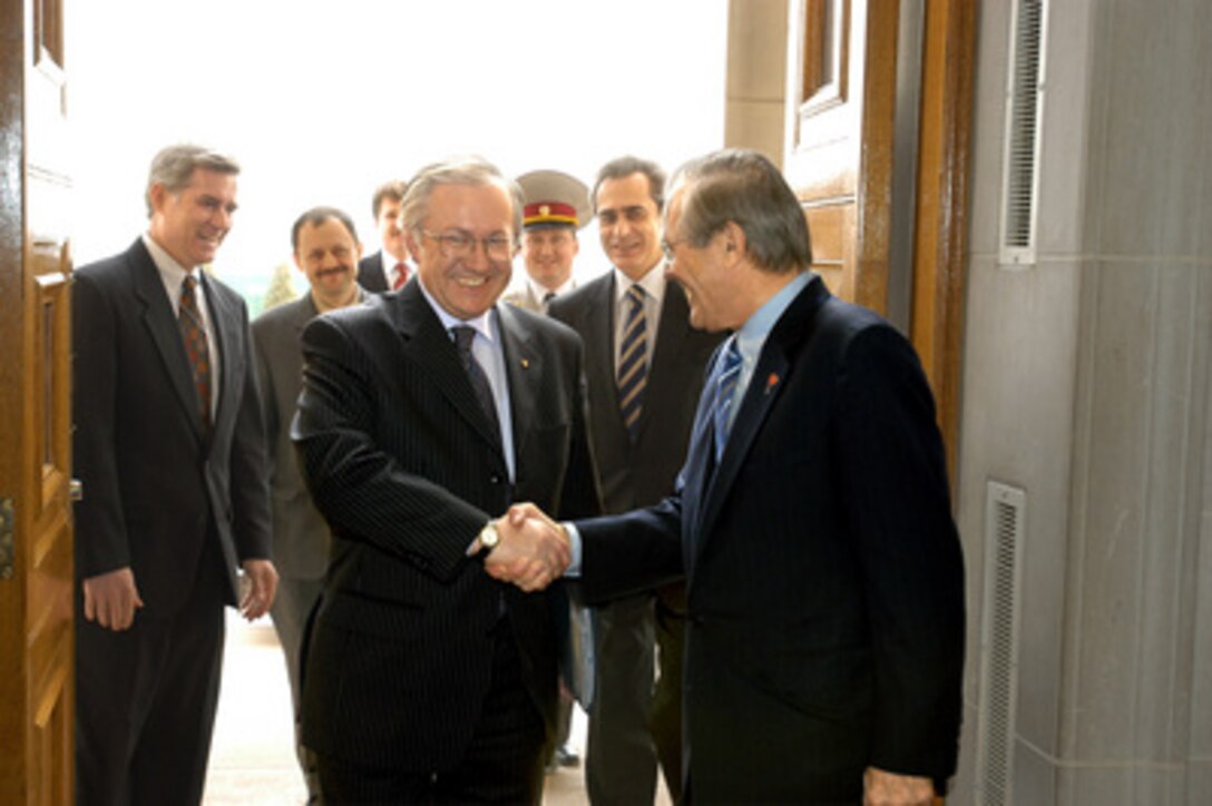 Secretary of Defense Donald H. Rumsfeld (right) welcomes Ukrainian Foreign Minister Borys Tarasyuk (center) at the Pentagon's River Entrance on March 11, 2005. Tarasyuk and his delegation are meeting with Rumsfeld and his senior policy advisors to discuss a range of bilateral security issues. 