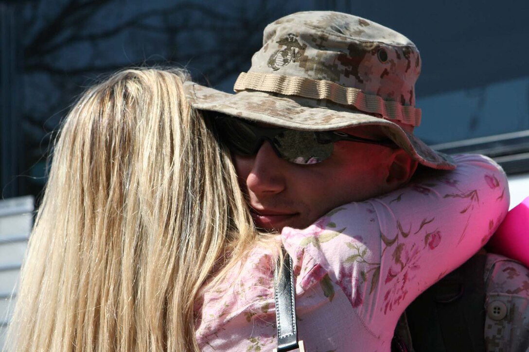 MARINE CORPS BASE CAMP LEJEUNE, N.C. - Staff Sergeant Eric M. Yurgartis, an analyst assigned with 2d Intelligence Battalion, II Marine Expeditionary Force, embraces his wife, Teresa, after arriving here from Iraq March 15.  Yurgartis, a Nazareth, Pa., native and more than 50 Marines with 2d Intelligence make up the first contingent from the unit returning from a seven-month deployment in support of Marine Corps operations in Iraq.  (Official U.S. Marine Corps photo by Cpl. Ruben D. Maestre)