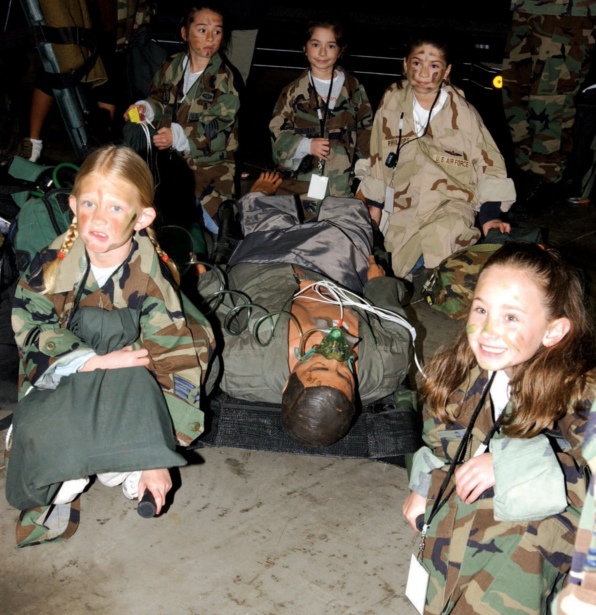 KADENA AIR BASE, Japan -- Children here prepare to carry a simulated casualty during an Operation Kids Understanding Deployment Operations event March 12.  More than 320 children participated in the event to learn more about how their military parents deploy.  (U.S. Air Force photo by Senior Airman Mercedes McAlister)